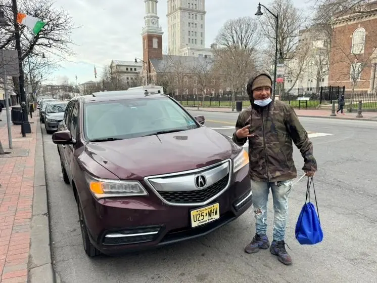 Basim Terry standing beside the vehicle he secured after finding full-time employment