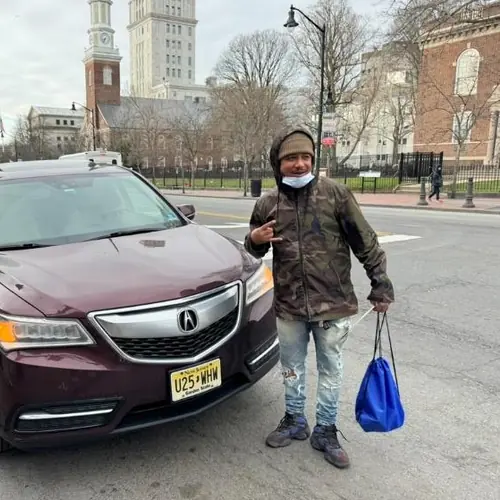 Basim Terry standing beside his vehicle