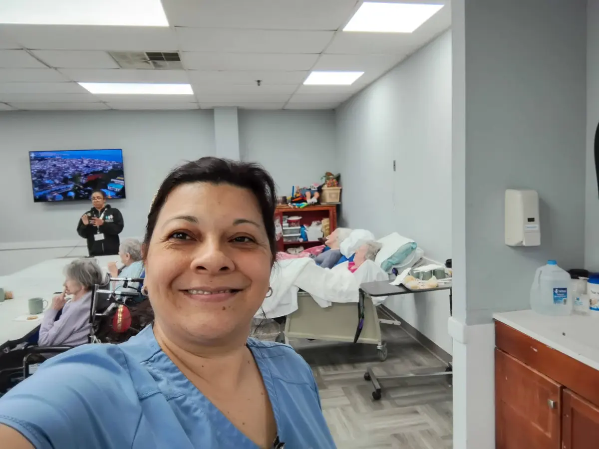 Eliana Gil in nursing scrubs while working in a senior care setting