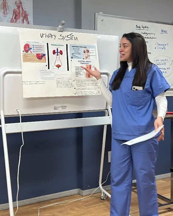 Laura Almonte Ramos presenting a nursing lesson during CNA training