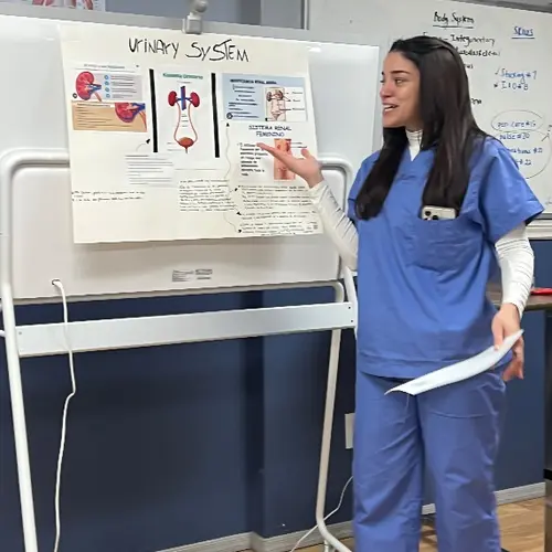 Laura Almonte Ramos presenting a nursing lesson during CNA training